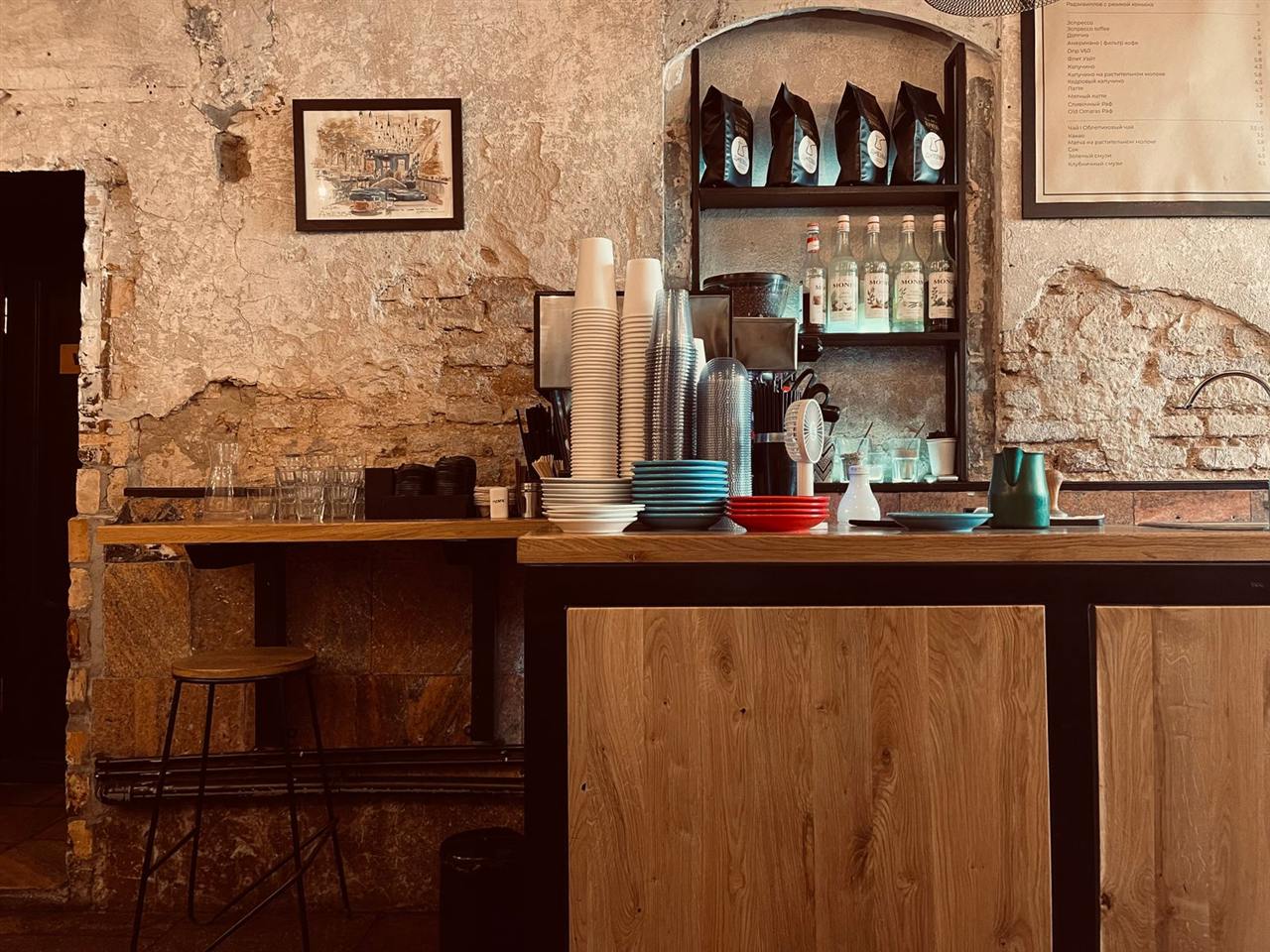 Comptoir de bar en bois, murs de pierre et étagères